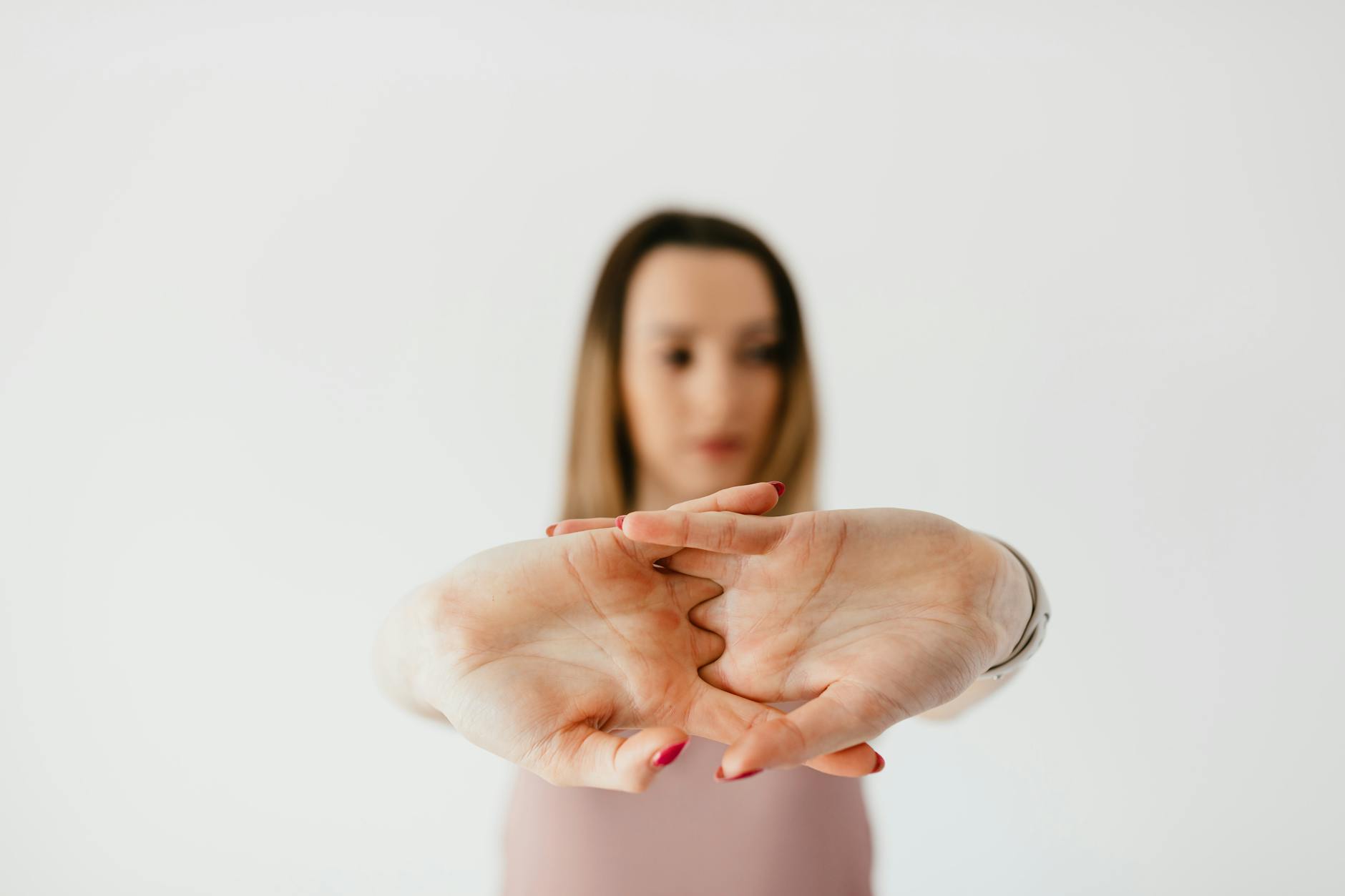 A serene woman practicing a gentle neck stretch in a calm environment.